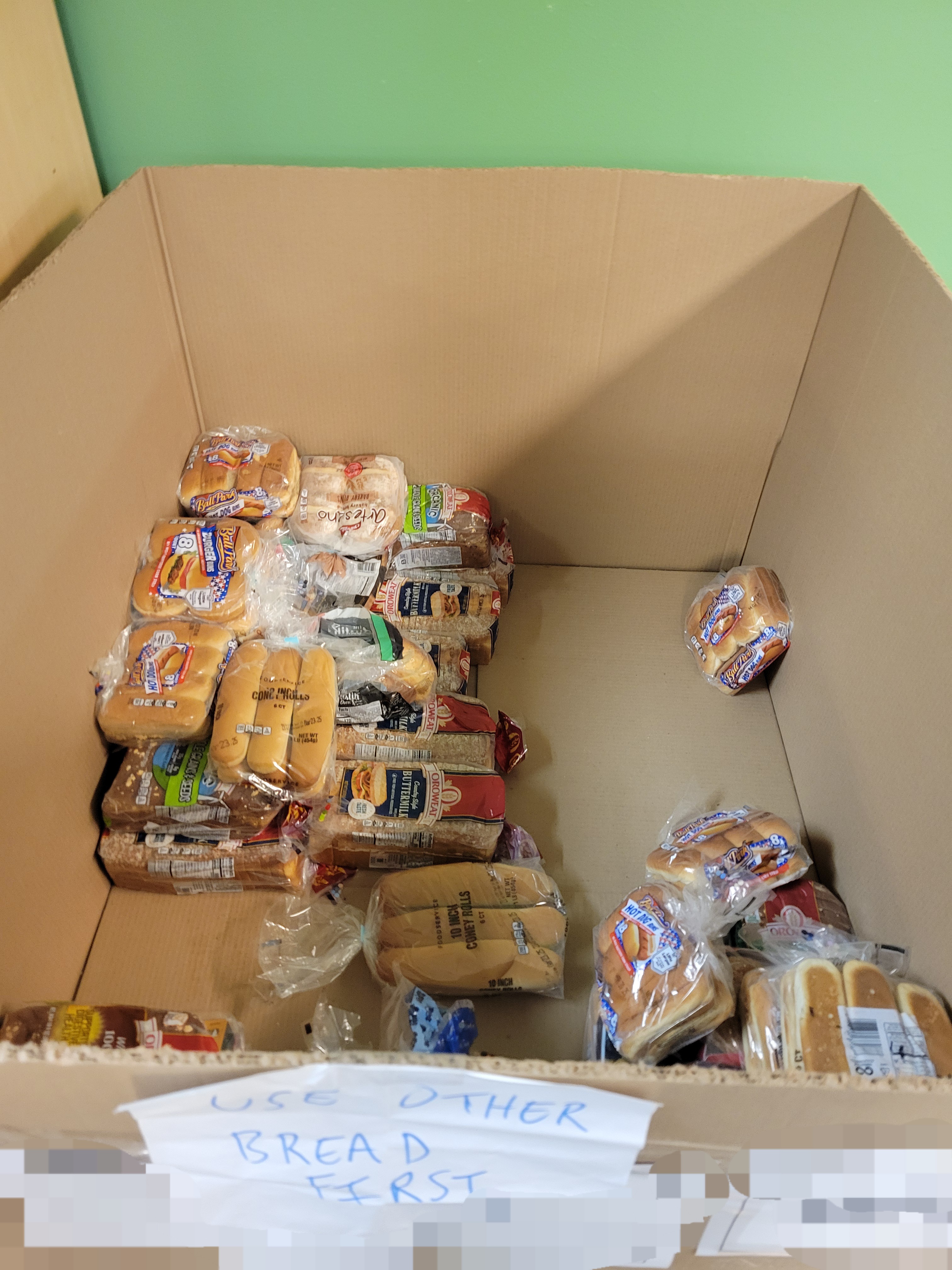 Cardboard container with bread on the bottom.